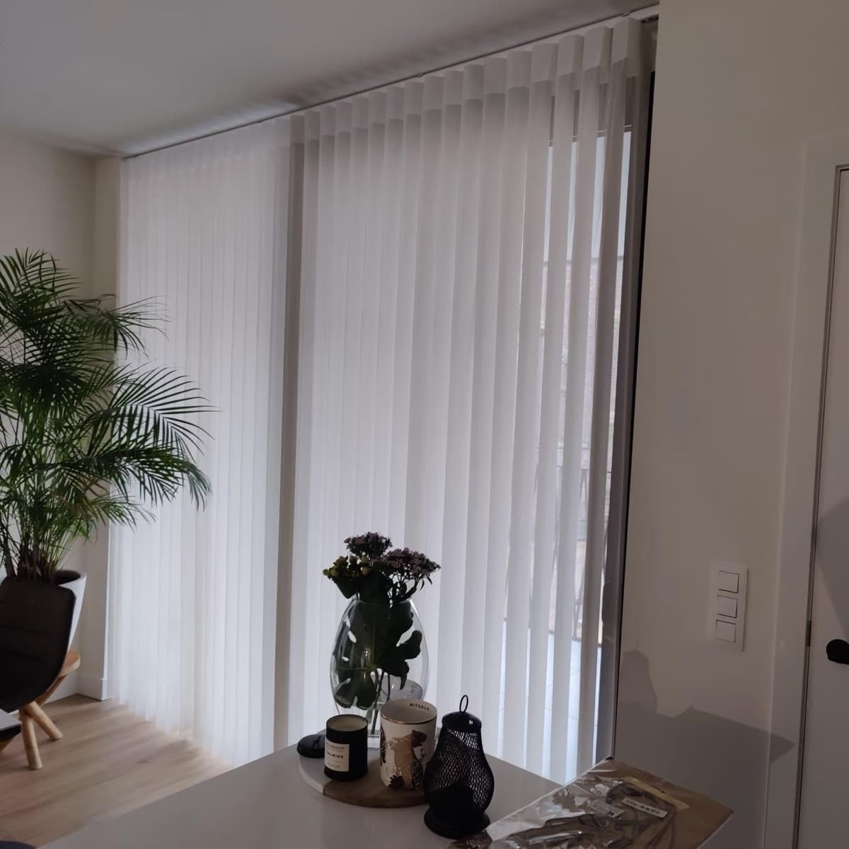 Witte verticale lamellen op maat voor een groot raam in de woonkamer - Sin-tex gordijnen en raamdecoratie, Heusden-Zolder